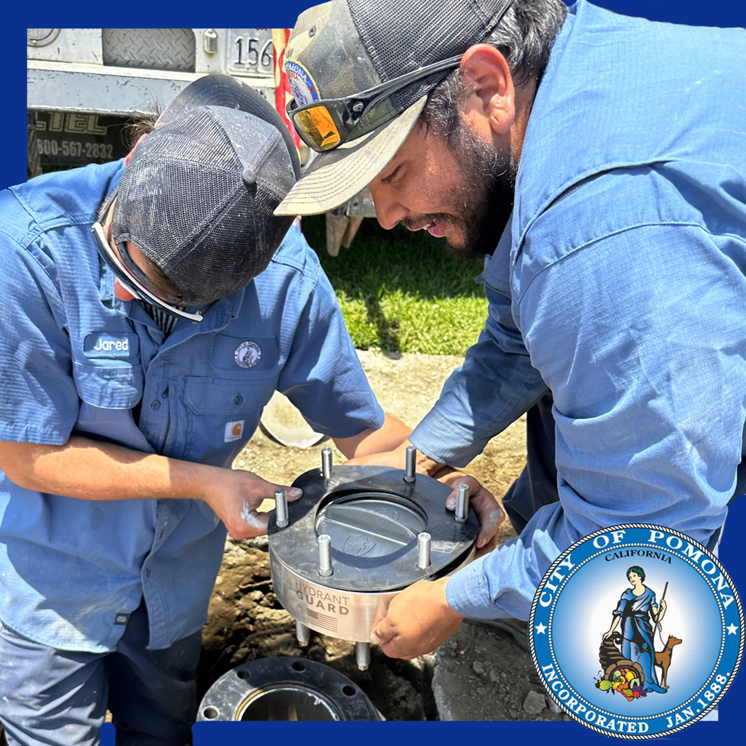 Water workers installing Hydrant Guard check valves on a fire hydrant in Pomona, California